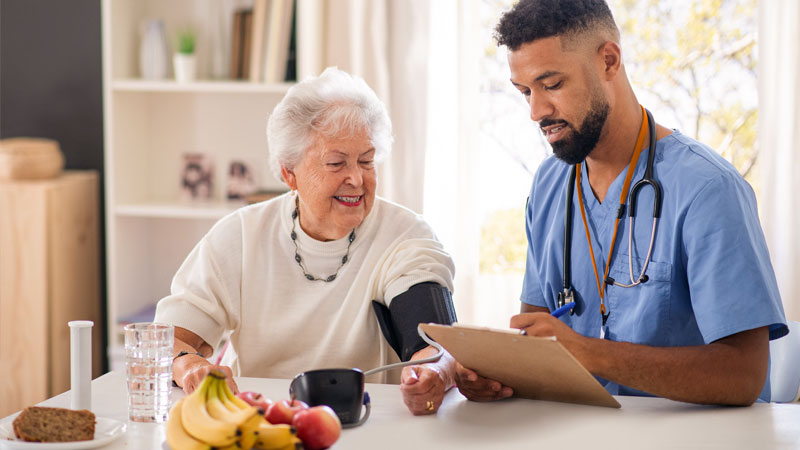 Doctor measuring patient blood pressure.